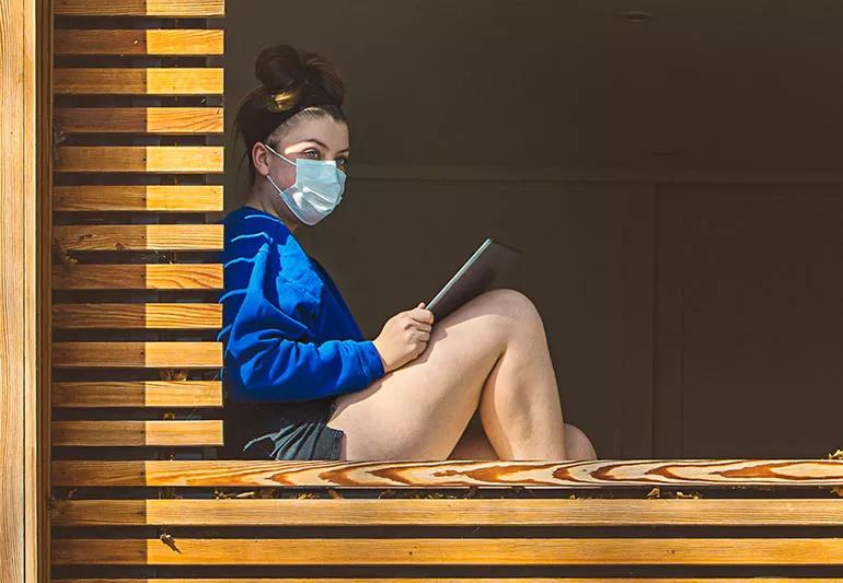 teenager isolated at home sitting in window