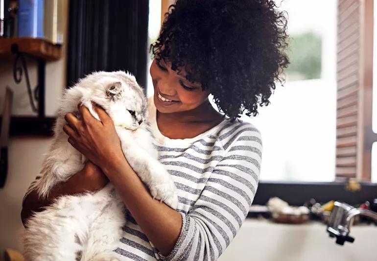 woman snuggling with her cat