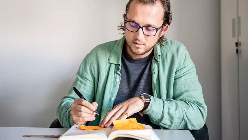 adult male managing a daily planner