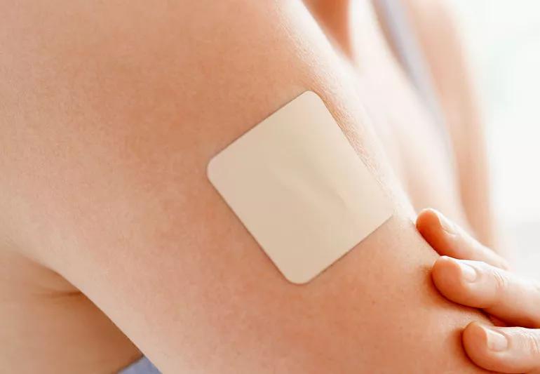 birth control patch on woman's arm