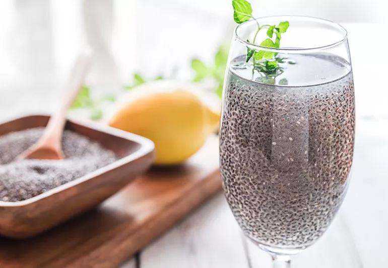 A glass of water with chia seeds in it