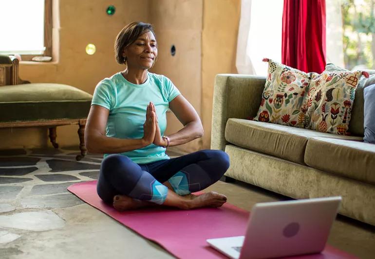 older woman performing yoga