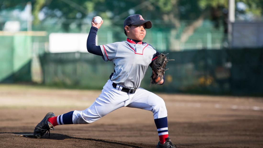 Child on baseball mound pitching