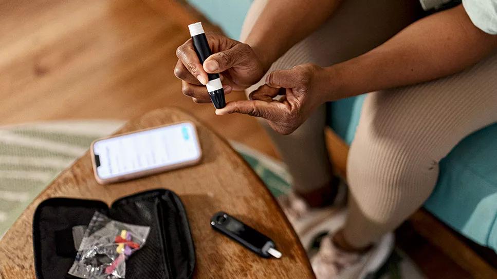 Person testing their blood sugar with their home kit