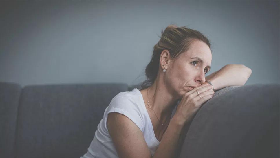 photo of woman looking anxious on a couch
