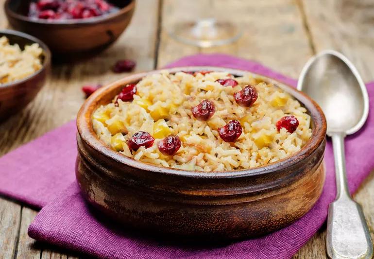 A rice pilaf dish containing brown rice, apples and dried fruit