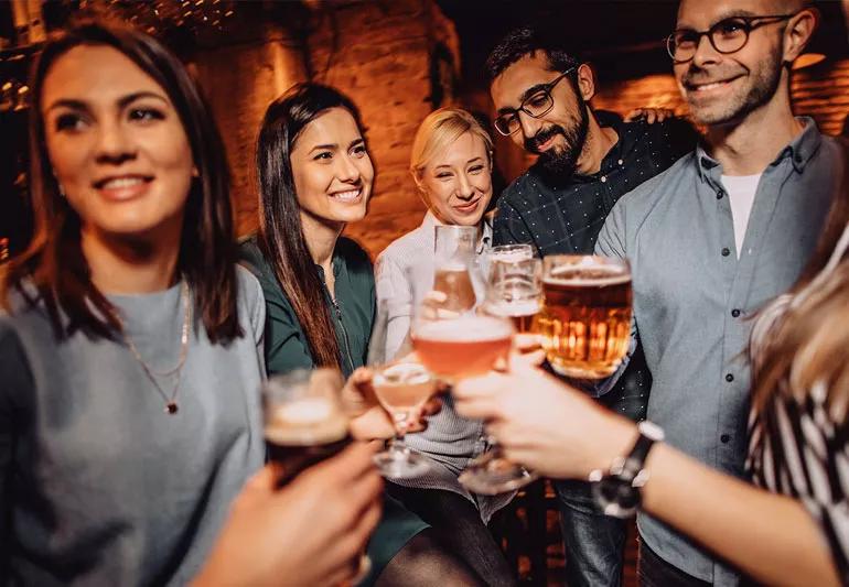 friends drinking alcohol at bar