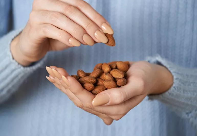 woman snacking on almonds