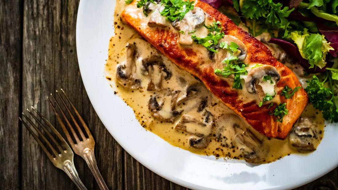 Plated salmon marsala, with leafy greens