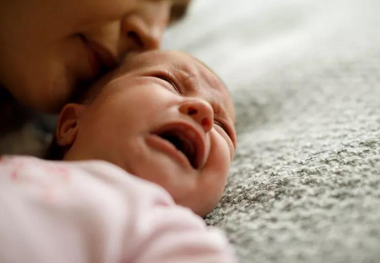 Mother calming her crying baby