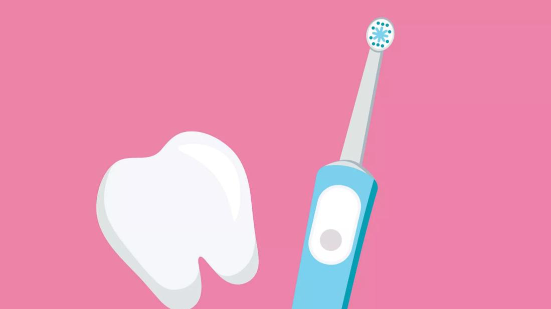 Electric toothbrush next to a tooth.