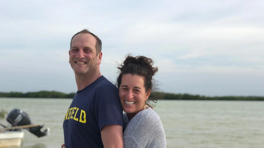 Richard Epstein and his partner hugging at the beach