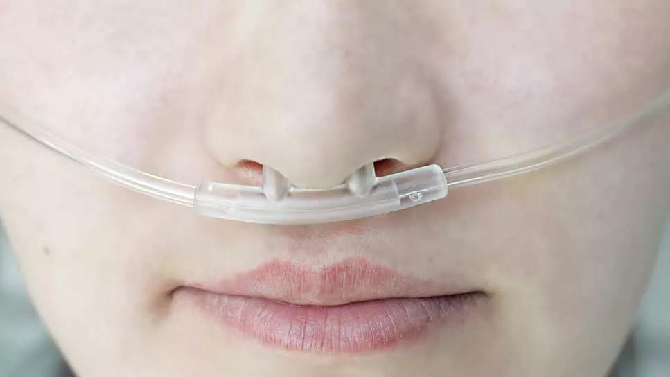 close up of a person with oxygen supply in nose