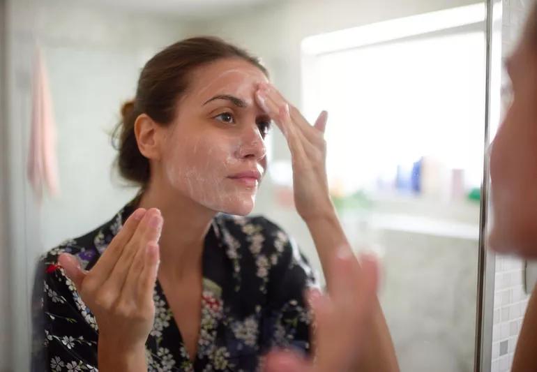 Woman adding probiotics to skin care regime