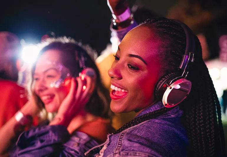 Women wearing headphones at concert