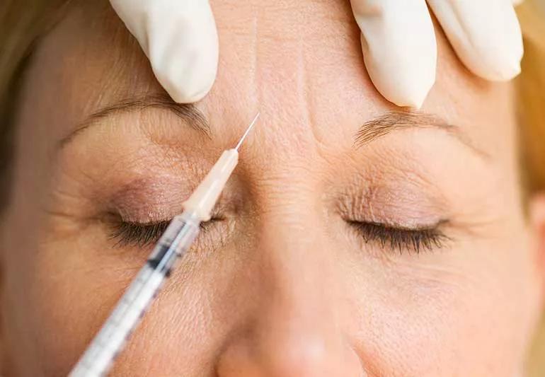 Person getting a brow injection.