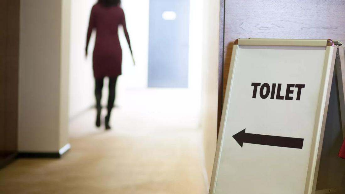 Woman rushing to bathroom