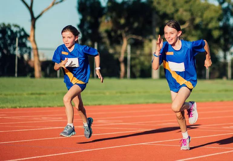 Kids competitively racing on a track