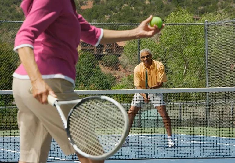 Older couple plays tennis