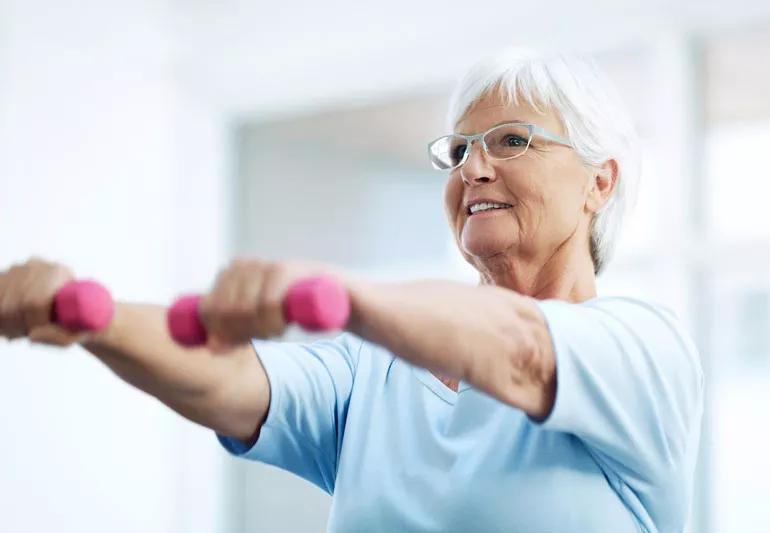 elderly woman lifting hand weights