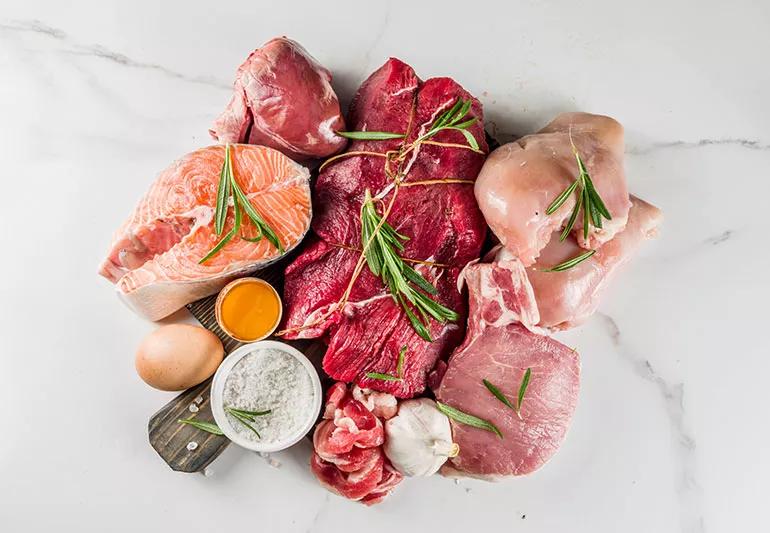 A pile of various kinds of raw meat and poultry