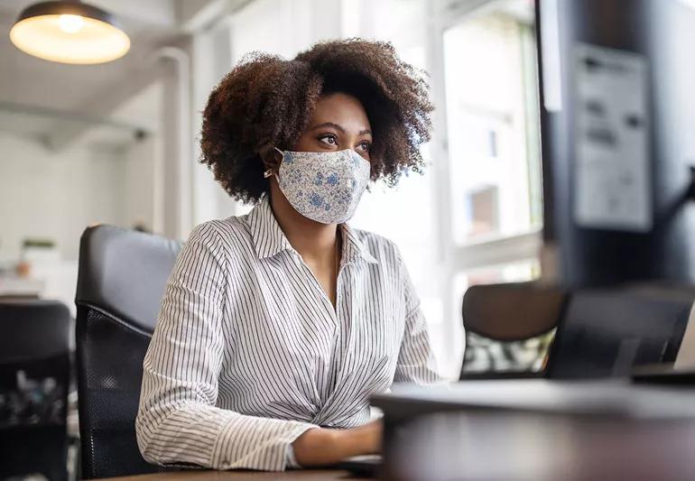 woman wearing a mask at work because of covid