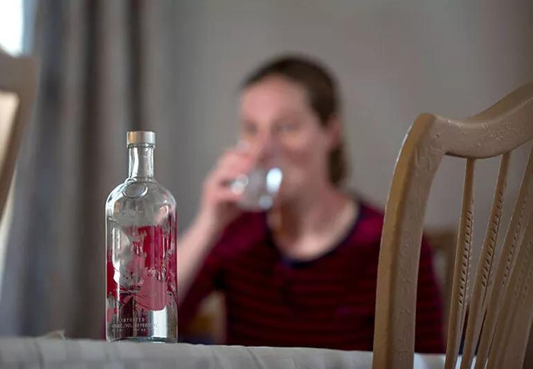 woman drinking alcohol at home