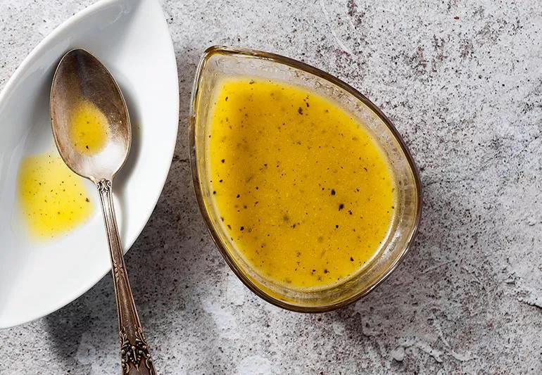 Salad dressing in bowl on marble counter