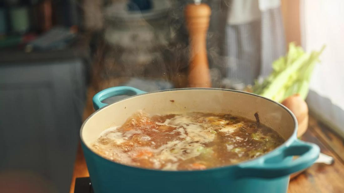 Pot of broth boiling on stove