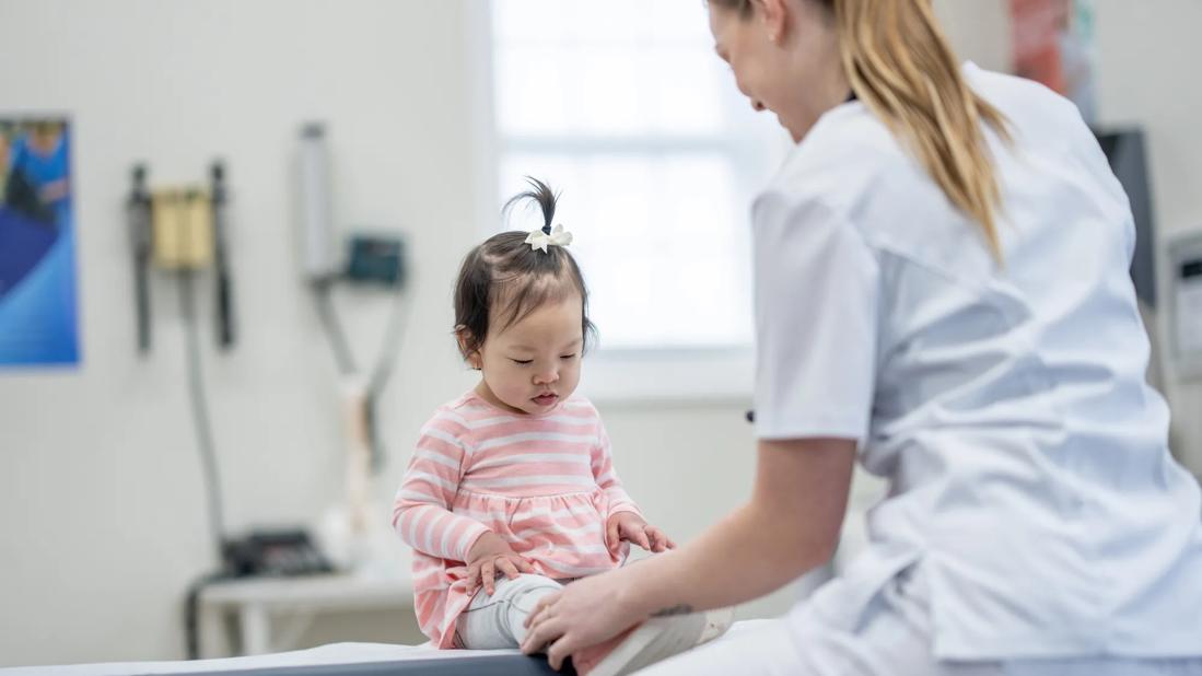 Healthcare provider examining a child in medical office