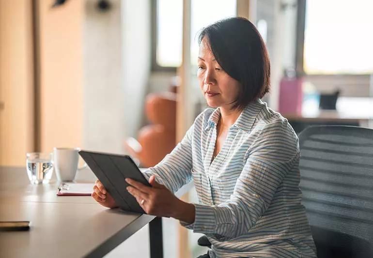 older woman doing research on mobile tablet