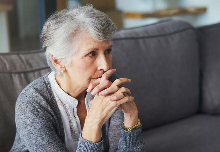 woman upset sitting on couch