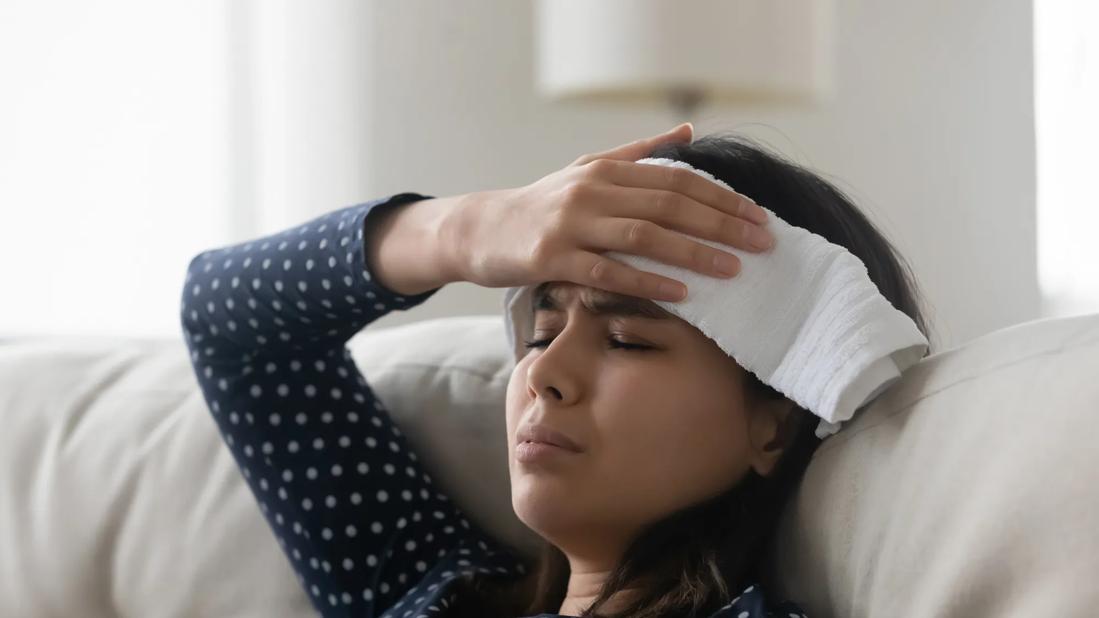 Person in distress holding a cloth over their head