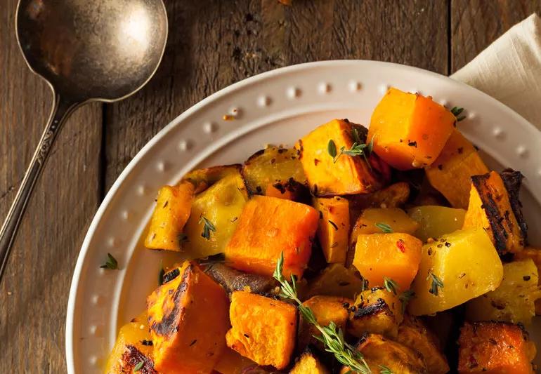 Roasted root vegetables in a white bowl