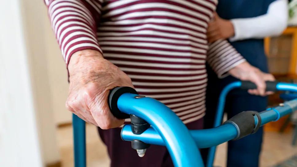 Elderly woman with a disability and a walker