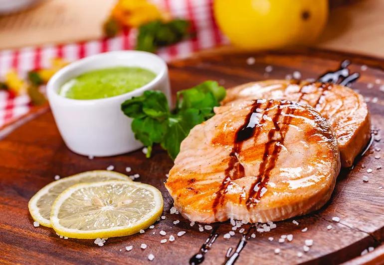 salmon steak on plate wtih lemons