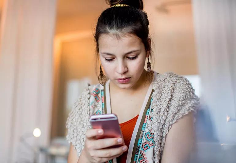 young woman accessing her social channels on her phone