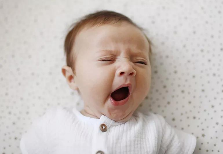 baby yawning in crib