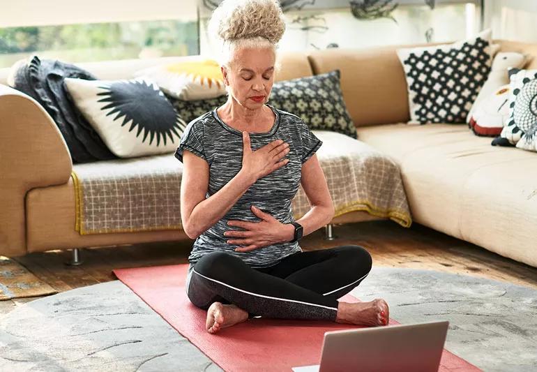 Person practicing breathing exercises to promote calmness.