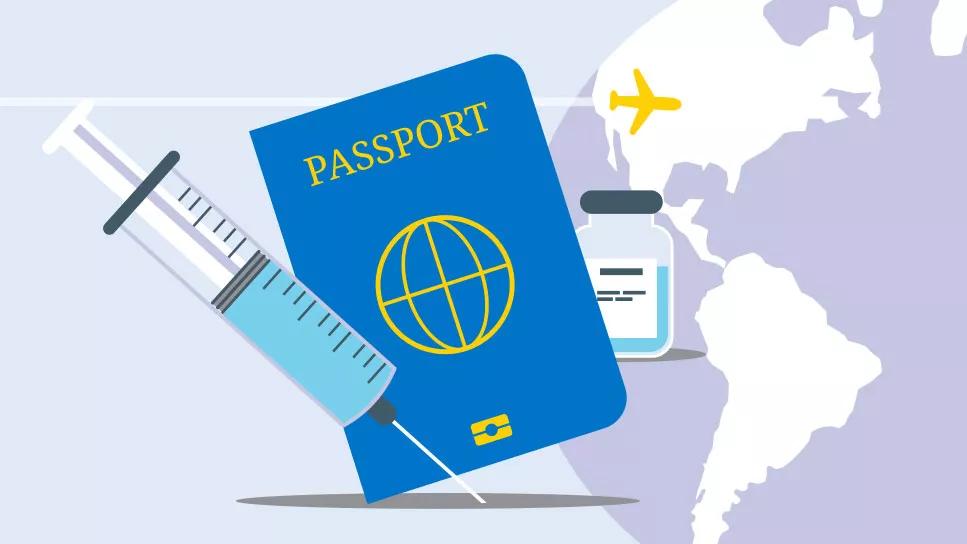 A vaccine syringe in front of a passport for international travel.
