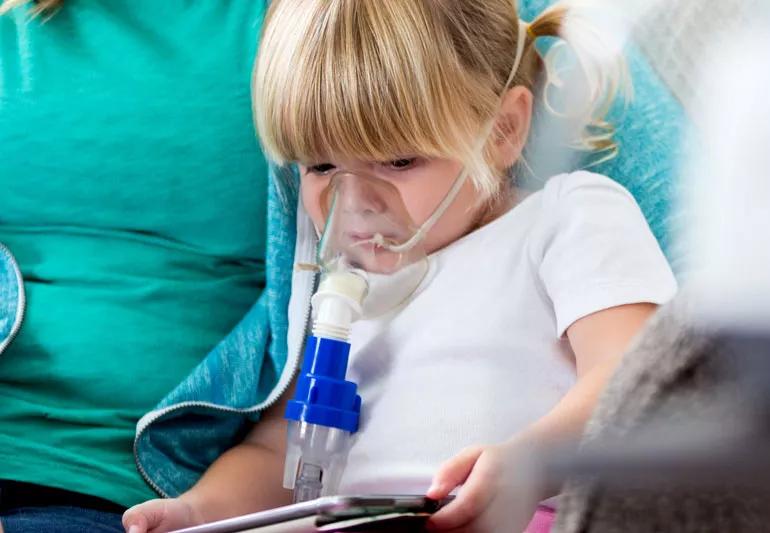 small child taking a breathing treatment