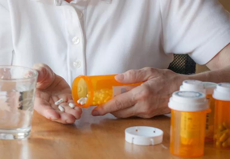 Elderly heart patient examining medication