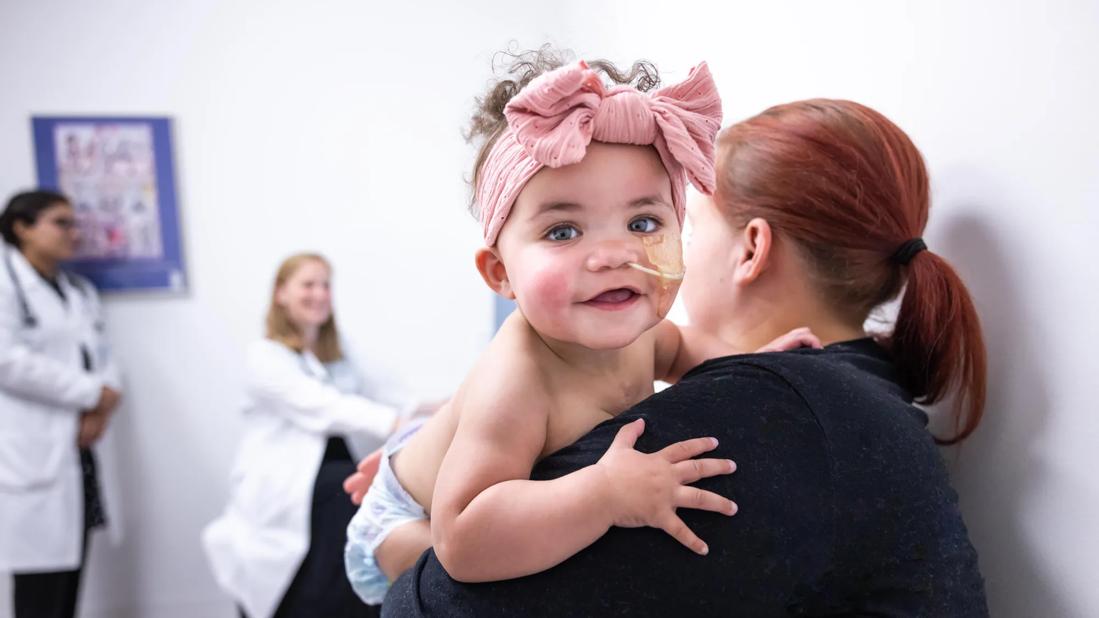Physician caring for infant on exam table