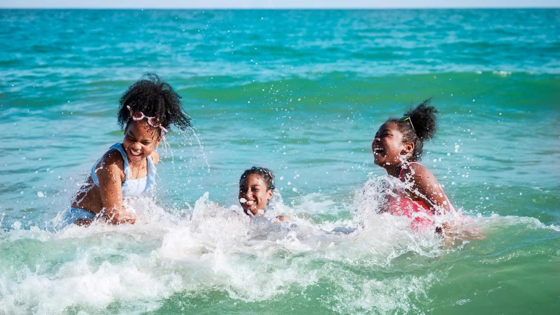 Kids playing in ocean/sea waves