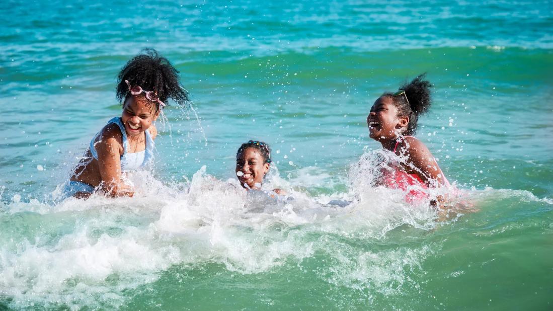 Kids playing in ocean/sea waves