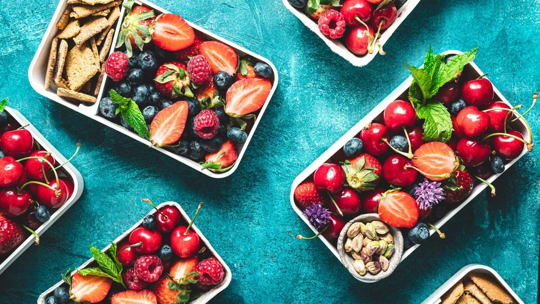 Containers of healthy fruit, nut and whole-wheat cracker snacks