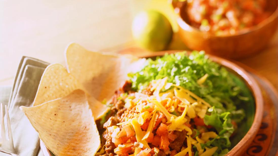 Taco salad and tortilla chips in a bowl