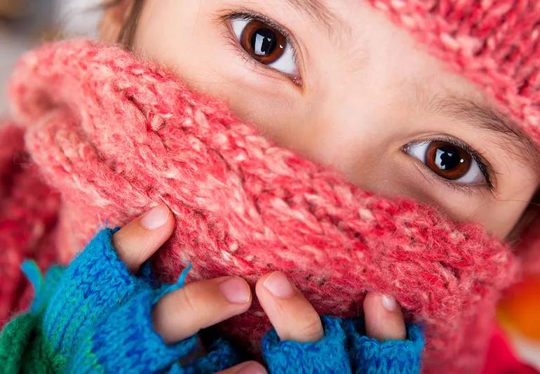 child wearing scarf over face in winter