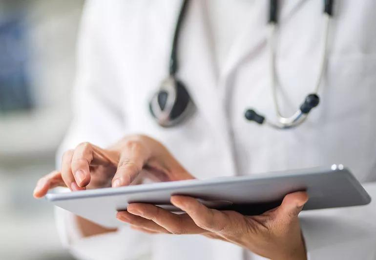 physician working on iPad in office