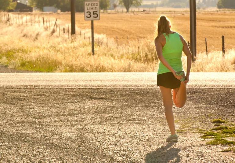 Woman stretching before beginning her run